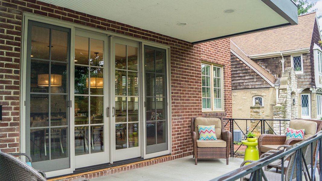 The front porch showing furniture with multi-colored accents and sliding doors into the dining area