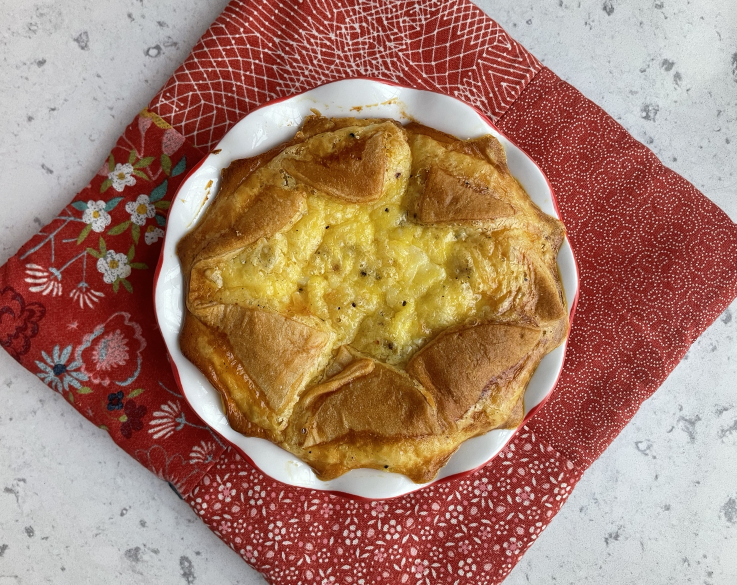 an egg souffles resting on a red hot pad