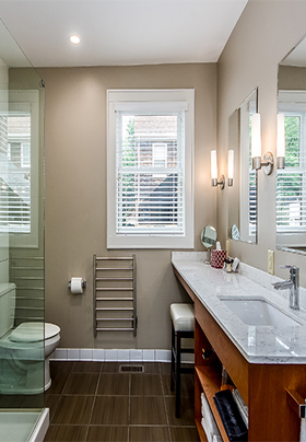 Interior of Room Two bathroom showing extended vanity with quartz counter and white linens