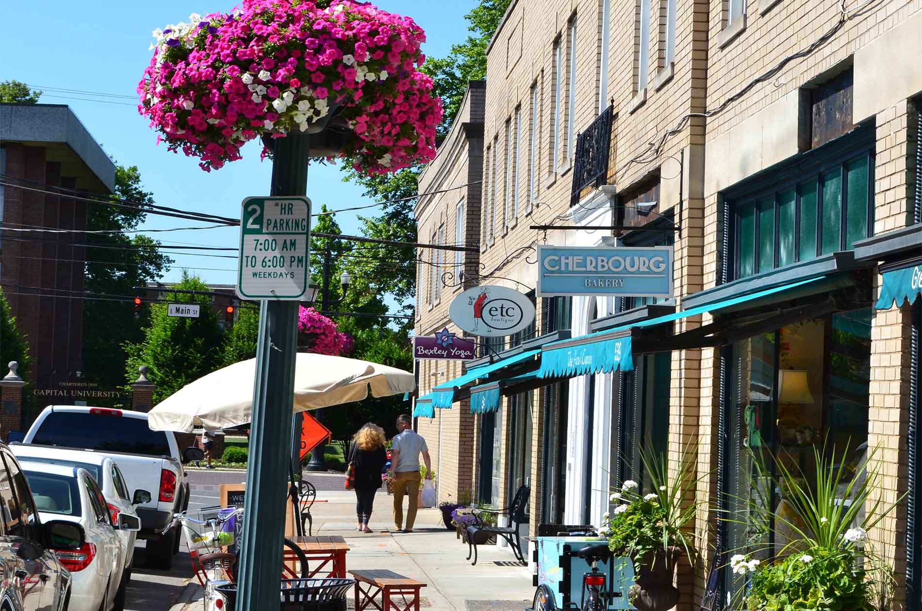 Southern view from the inn which includes a gluten-free bakery, a boutique, and a yoga studio under bright blue awnings